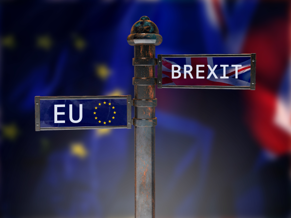 Finger signpost with arms pointing to EU and Brexit, against background of UK & EU flags