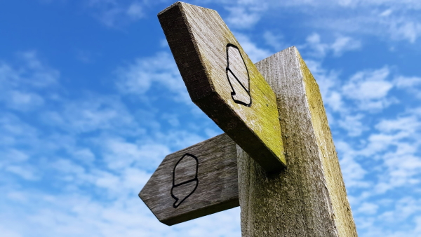 signpost with two directions marked with fingers