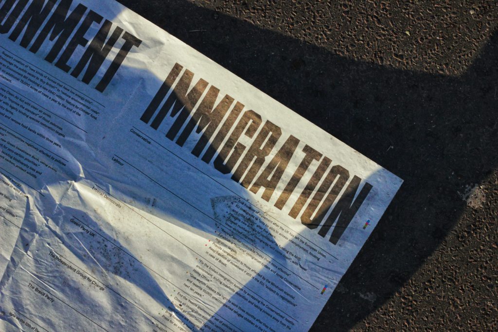 Picture of a newspaper with immigration as the headline