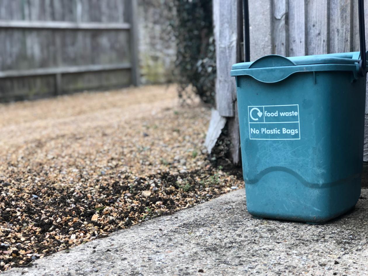 A household recycling bin on a driveway