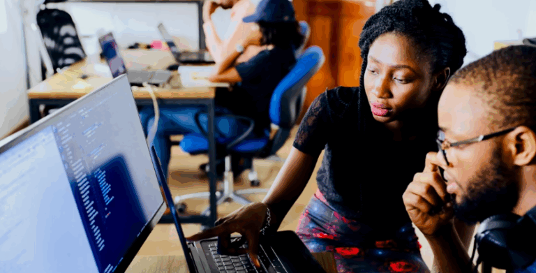 Two people working together at a computer