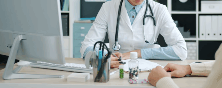 A doctor and patient sat at a desk