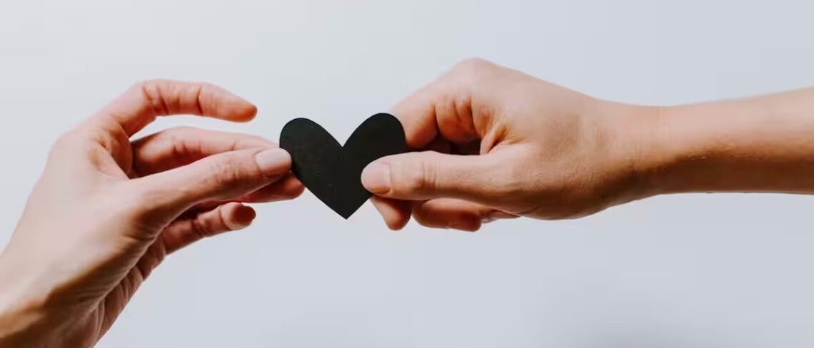 Two hands holding a heart