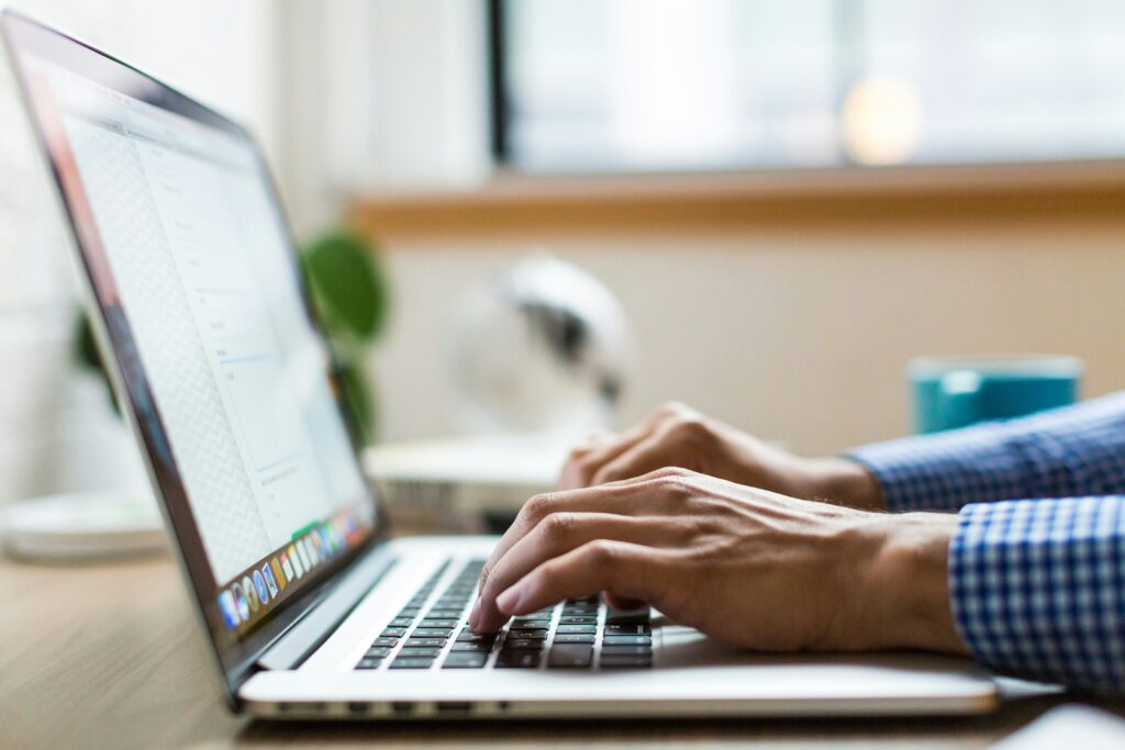 Someone typing on a laptop
